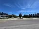 A wide shot of a neighborhood roundabout, showcasing pristine landscaping and community signs at 5771 Mangrove Cove Ave, Winter Garden, FL 34787