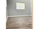 Bright bedroom features neutral walls, white trim, and laminate flooring, with a single window at 5830 Beechmont Blvd, Orlando, FL 32808