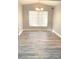 Bright dining area featuring new wood-look flooring, and a large window at 5830 Beechmont Blvd, Orlando, FL 32808