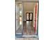 Bright entryway with hardwood floors and a red door leading to the living room with french doors at 5830 Beechmont Blvd, Orlando, FL 32808