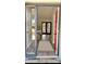 Bright and inviting entryway with a red door, wood floors, and view of the living space with french doors at 5830 Beechmont Blvd, Orlando, FL 32808