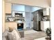 Modern kitchen with stainless steel appliances, granite countertops, and a view into the adjacent living area at 5830 Beechmont Blvd, Orlando, FL 32808