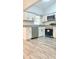 Bright kitchen features modern appliances, white cabinets, granite countertops, and wood-look flooring at 5830 Beechmont Blvd, Orlando, FL 32808