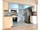 Well-equipped kitchen with stainless steel appliances and granite countertops, open to living area at 5830 Beechmont Blvd, Orlando, FL 32808