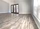 Expansive living area featuring wood floors, large windows, and glass doors that flood the space with natural light at 5830 Beechmont Blvd, Orlando, FL 32808