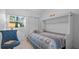 Cozy bedroom featuring a murphy bed and a comfortable blue chair near a sunlit window at 610 Chestnut Oak Cir # 114, Altamonte Springs, FL 32701