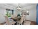 Cozy dining area featuring a modern chandelier and a table set with plush chairs, adjacent to outdoor views at 610 Chestnut Oak Cir # 114, Altamonte Springs, FL 32701