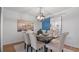 Charming dining room featuring a stylish chandelier, dining table set, and a vibrant blue sliding barn door at 610 Chestnut Oak Cir # 114, Altamonte Springs, FL 32701