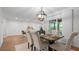 Open dining area with stylish chandelier and dining table that connects to the spacious living area at 610 Chestnut Oak Cir # 114, Altamonte Springs, FL 32701