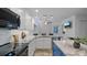 Modern kitchen with white cabinets, stainless steel appliances, and a gray marble countertop island at 610 Chestnut Oak Cir # 114, Altamonte Springs, FL 32701