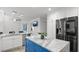 Bright kitchen featuring a blue island with marble countertop and stainless steel appliances at 610 Chestnut Oak Cir # 114, Altamonte Springs, FL 32701