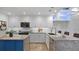 Updated kitchen features stainless steel appliances, a center island with seating, and modern white cabinetry at 610 Chestnut Oak Cir # 114, Altamonte Springs, FL 32701