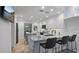 Updated kitchen features stainless steel appliances, a center island with seating, and modern white cabinetry at 610 Chestnut Oak Cir # 114, Altamonte Springs, FL 32701