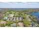 Sweeping aerial view showcasing the golf course, lake, and upscale community with lush trees at 6120 Payne Stewart Dr, Windermere, FL 34786