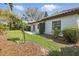 Backyard with a lush lawn, stone patio, and tropical landscaping at 6120 Payne Stewart Dr, Windermere, FL 34786