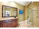 Bathroom with granite countertops, glass shower, and decorative mirror at 6120 Payne Stewart Dr, Windermere, FL 34786