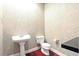 Powder room featuring classic pedestal sink and floral wallpaper at 6120 Payne Stewart Dr, Windermere, FL 34786