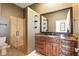 Bathroom with glass shower, dark vanity and unique wallpaper at 6120 Payne Stewart Dr, Windermere, FL 34786