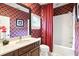 Bathroom featuring a vanity with marble countertop and decorative wallpaper at 6120 Payne Stewart Dr, Windermere, FL 34786