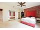 Bright bedroom features a ceiling fan, mirrored closet, and ensuite bath at 6120 Payne Stewart Dr, Windermere, FL 34786