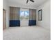 Bright bedroom featuring large window, neutral carpet, and baseboard trim at 6120 Payne Stewart Dr, Windermere, FL 34786