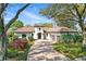Beautiful single-story home featuring a red tile roof, well-manicured lawn and a brick driveway at 6120 Payne Stewart Dr, Windermere, FL 34786