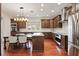 Spacious kitchen with stainless steel appliances, granite countertops, and dark wood cabinets at 6120 Payne Stewart Dr, Windermere, FL 34786