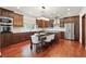 Bright kitchen features stainless steel appliances, wood cabinetry, and eat in dining area at 6120 Payne Stewart Dr, Windermere, FL 34786
