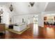 Bright, open living space featuring hardwood floors, vaulted ceiling and a view to the kitchen at 6120 Payne Stewart Dr, Windermere, FL 34786