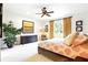 Bright main bedroom with ceiling fan, dresser, and ensuite bath at 6120 Payne Stewart Dr, Windermere, FL 34786