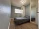 Cozy bedroom featuring wood floors, built in closet and a twin bed with a grey comforter at 655 Katherine Ave, Orlando, FL 32810