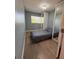 Cozy bedroom featuring wood floors, built in closet and a twin bed with a grey comforter at 655 Katherine Ave, Orlando, FL 32810
