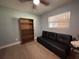 Bedroom featuring a ceiling fan, a bookshelf, futon and wood flooring at 655 Katherine Ave, Orlando, FL 32810