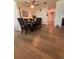 An open dining room features wood flooring, a ceiling fan, and black dining furniture with seating for four at 655 Katherine Ave, Orlando, FL 32810