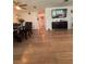 An open dining room features wood flooring, a ceiling fan, and black dining furniture with seating for four at 655 Katherine Ave, Orlando, FL 32810
