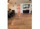 An open dining room features wood flooring, a ceiling fan, and black dining furniture with seating for four at 655 Katherine Ave, Orlando, FL 32810
