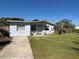 Charming single-story home with a well-maintained front yard and a concrete driveway at 655 Katherine Ave, Orlando, FL 32810