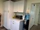 A bright kitchen features white cabinets, stainless steel appliances, and stylish hardware throughout at 655 Katherine Ave, Orlando, FL 32810