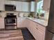 Well-equipped kitchen with stainless steel appliances, white cabinets, and a stylish backsplash at 655 Katherine Ave, Orlando, FL 32810