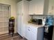 Functional kitchenette with white cabinets, counter space, and a fruit basket on a stand at 655 Katherine Ave, Orlando, FL 32810