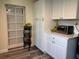 Functional kitchenette with white cabinets, counter space, and a fruit basket on a stand at 655 Katherine Ave, Orlando, FL 32810