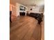 This living room features hardwood floors, dark leather furniture, and a ceiling fan for comfort at 655 Katherine Ave, Orlando, FL 32810