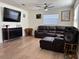 Cozy living room featuring a plush brown leather sectional and sleek entertainment center at 655 Katherine Ave, Orlando, FL 32810
