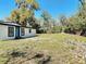 Spacious backyard featuring a well-maintained lawn and a charming home exterior at 709 S Parsons Ave, Deland, FL 32720