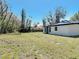 Picturesque view of a large backyard surrounded by mature trees and lush greenery at 709 S Parsons Ave, Deland, FL 32720