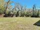 Expansive backyard featuring a well-maintained lawn, bordered by a wooden fence, offering privacy at 709 S Parsons Ave, Deland, FL 32720