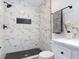 Modern bathroom with marble-style tiling, black hardware and a tiled niche at 709 S Parsons Ave, Deland, FL 32720