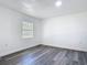 Clean bedroom with modern flooring and a well-lit window at 709 S Parsons Ave, Deland, FL 32720