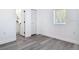 Bedroom showcasing an ensuite bathroom, neutral walls, and wood-look flooring at 709 S Parsons Ave, Deland, FL 32720