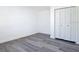 Bedroom featuring wood-style flooring, baseboard trim, and closet at 709 S Parsons Ave, Deland, FL 32720